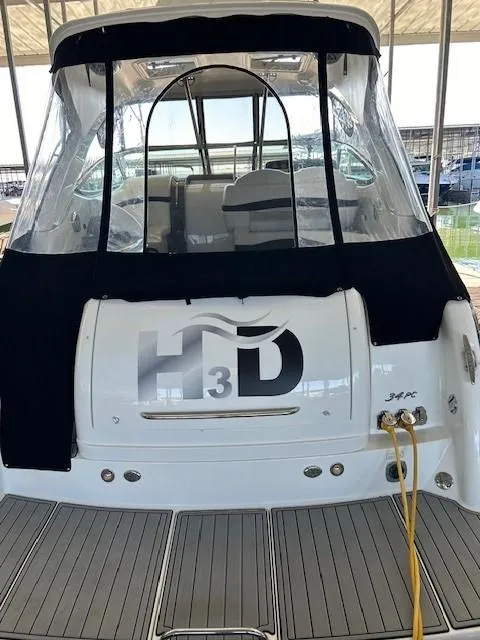 Slide: The Image of 2015 Formula 34 PC boat with black canopy and docked at marina. - 10