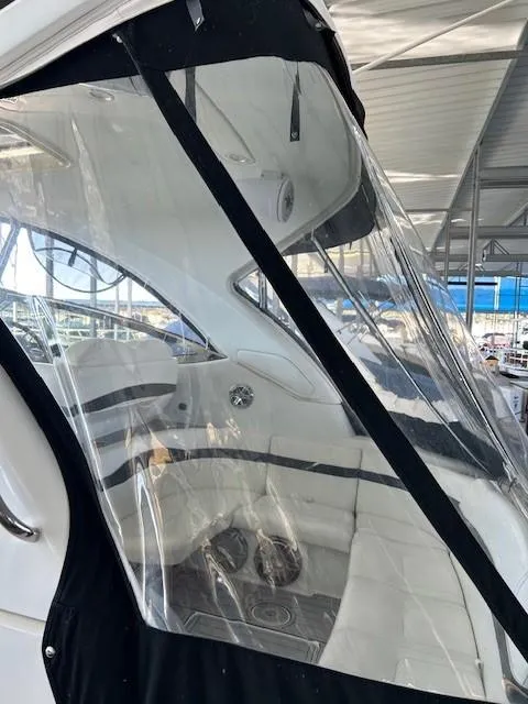 Slide: The Image of 2015 Formula 34 PC boat interior with clear enclosure and white seating. - 14