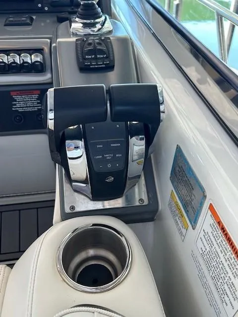 Slide: The Image of Control panel of a 2015 Formula 34 PC boat with throttle levers and cup holder. - 16