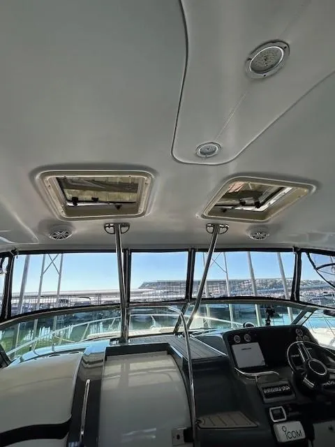 Slide: The Image of Interior view of a 2015 Formula 34 PC yacht cockpit with sunroof and control panel. - 19
