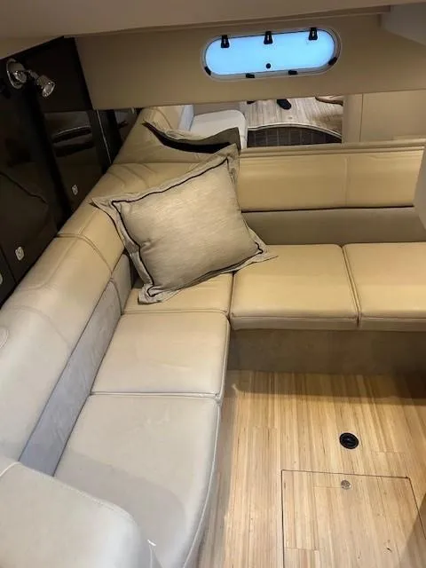 Slide: The Image of 2015 Formula 34 PC yacht interior with beige leather seating and wooden flooring. - 34