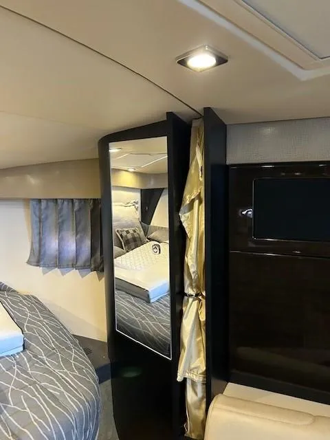 Slide: The Image of Interior of 2015 Formula 34 PC yacht, featuring a cozy cabin with modern furnishings. - 38