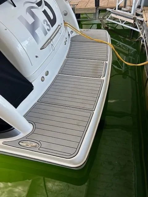 Slide: The Image of 2015 Formula 34 PC boat with swim platform docked in green water. - 43