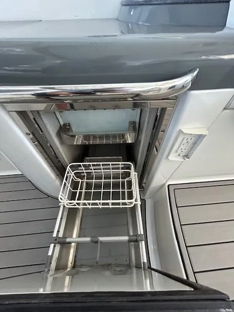 Slide: The Image of 2015 Formula 34 PC boat with open storage compartment and metal basket. - 45