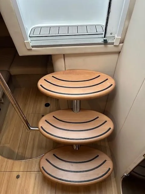 Slide: The Image of Wooden steps inside a 2015 Formula 34 PC boat, featuring sleek design and modern finish. - 46