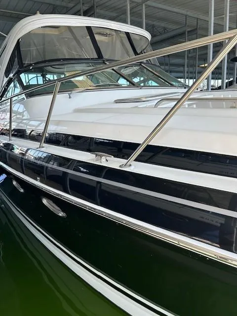 Slide: The Image of 2015 Formula 34 PC yacht in marina, sleek design, white and black exterior. - 7