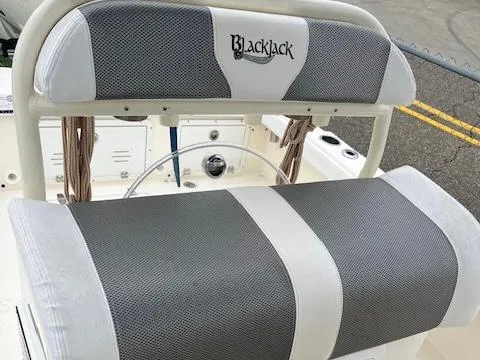 Slide: The Image of 2021 BlackJack 256 Coastal Bay boat seating with gray and white upholstery. - 10
