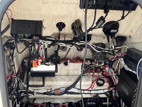 Slide: The Image of Electrical wiring and components inside a 2021 BlackJack 256 Coastal Bay boat. - 11