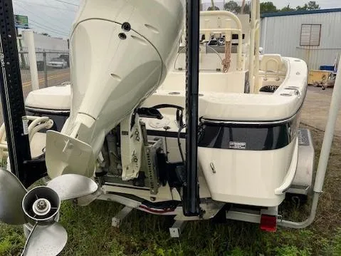 Slide: The Image of 2021 BlackJack 256 Coastal Bay boat with outboard motor, rear view. - 2