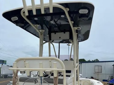 Slide: The Image of 2021 BlackJack 256 Coastal Bay boat with T-top and seating, docked outdoors. - 4