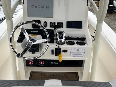Slide: The Image of 2021 BlackJack 256 Coastal Bay boat console with Garmin navigation and steering wheel. - 5