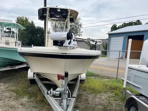 Slide: The Image of 2021 BlackJack 256 Coastal Bay boat on trailer, parked outdoors near a storage facility. - 6