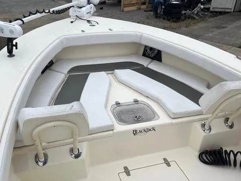 Slide: The Image of 2021 BlackJack 256 Coastal Bay boat with cushioned seating and storage compartments. - 8