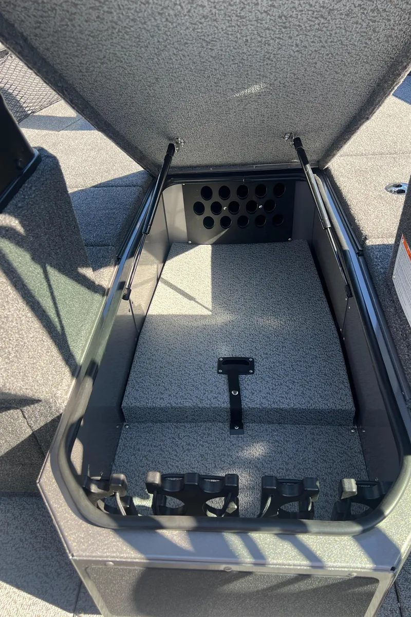 Slide: The Image of 2025 Lund 2075 IMPACT XS boat storage compartment, open lid, interior view. - 13