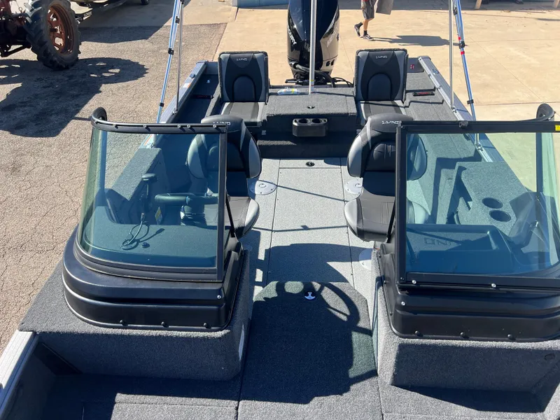 Slide: The Image of 2025 Lund 2075 IMPACT XS boat interior with seating and windshield. - 14