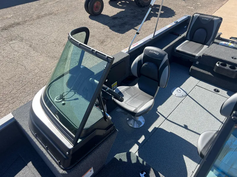 Slide: The Image of 2025 Lund 2075 IMPACT XS boat interior with seating and steering console. - 15