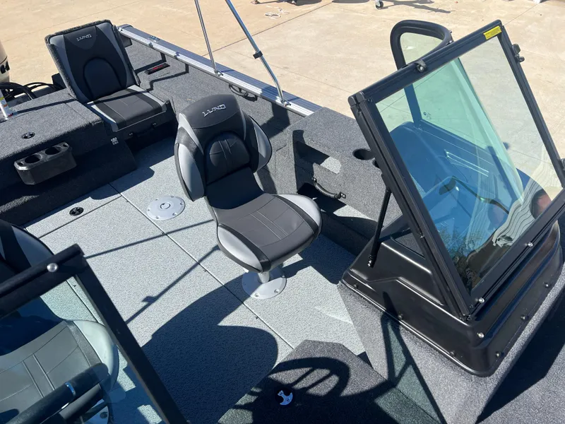 Slide: The Image of 2025 Lund 2075 IMPACT XS boat interior with seating and windshield. - 16