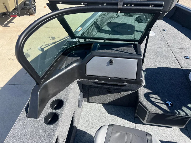 Slide: The Image of 2025 Lund 2075 IMPACT XS boat interior with windshield and seating area. - 18