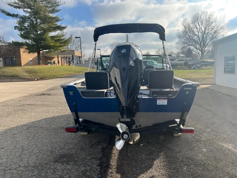 Slide: The Image of 2025 Lund 2075 IMPACT XS boat, rear view, parked outdoors on a sunny day. - 6