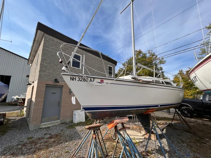 Slide: The Image of 1986 CAL 22 sailboat on stands near a building, ready for maintenance. - 1