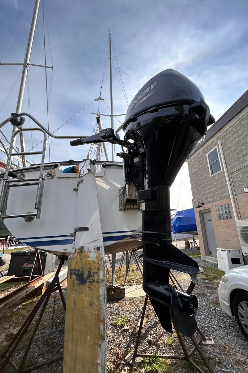Slide: The Image of Outboard motor on a 1986 CAL 22 sailboat in a boatyard. - 18