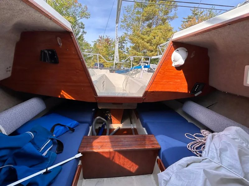 Slide: The Image of Interior of 1986 CAL 22 sailboat with blue cushions and wooden accents. - 27