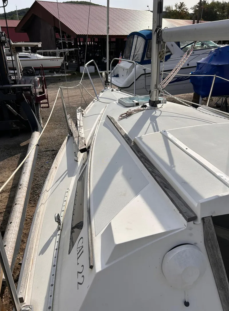 Slide: The Image of 1986 CAL 22 sailboat docked, showcasing deck and rigging details. - 5
