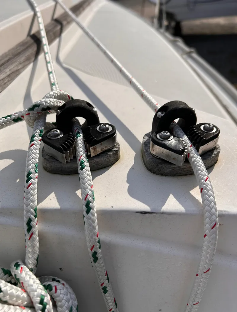 Slide: The Image of Close-up of CAL 22 sailboat rigging, featuring cleats and ropes, 1986 model. - 8