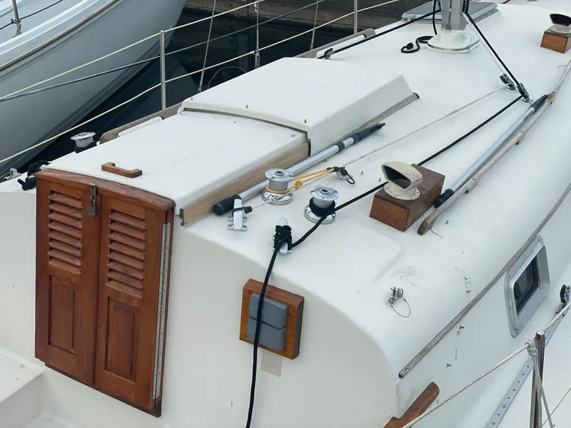 Slide: The Image of 1985 Bayfield 32 sailboat deck with wooden hatch and rigging equipment. - 10