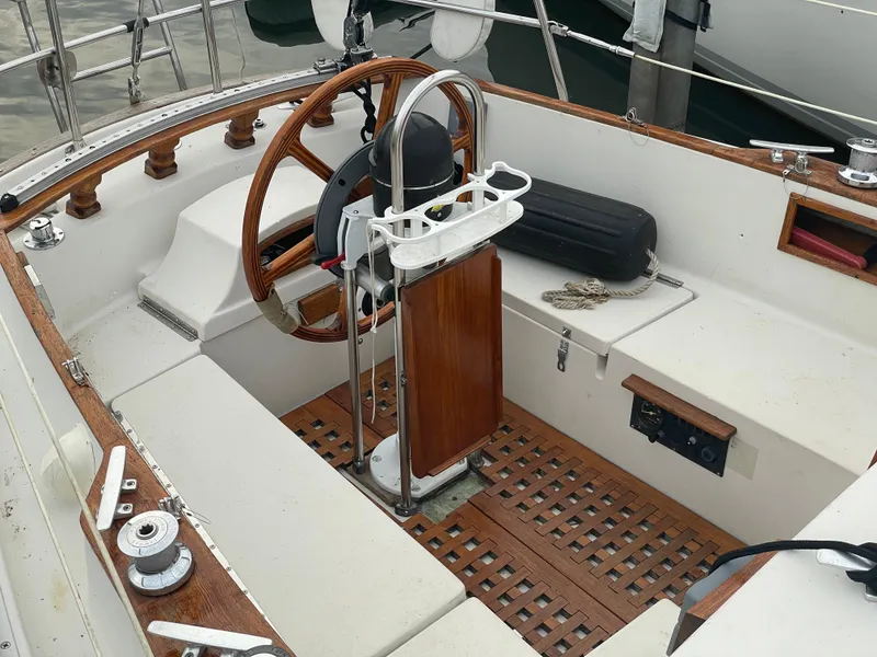 Slide: The Image of 1985 Bayfield 32 sailboat cockpit with wooden wheel and seating. - 12