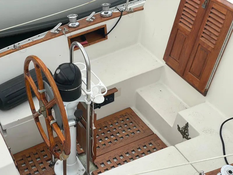 Slide: The Image of 1985 Bayfield 32 sailboat cockpit with wooden wheel and seating. - 13