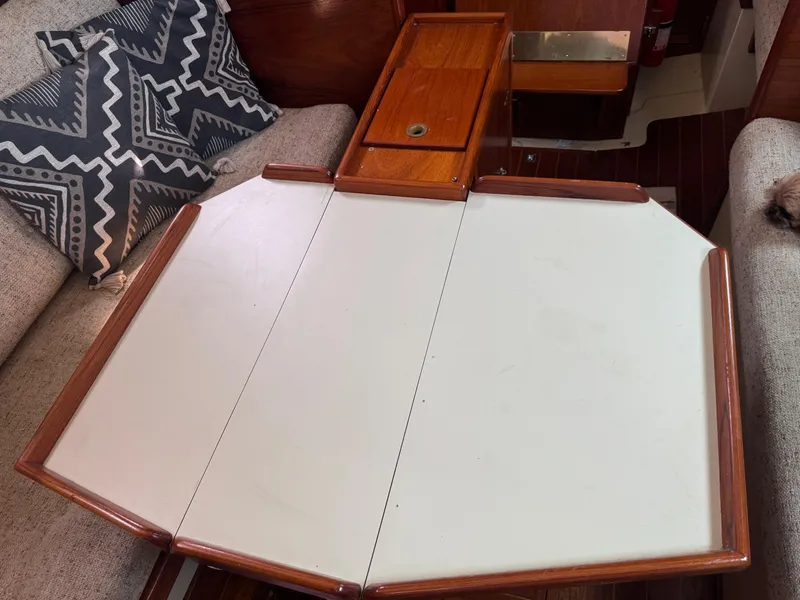 Slide: The Image of 1985 Bayfield 32 sailboat interior with foldable table and patterned cushions. - 20