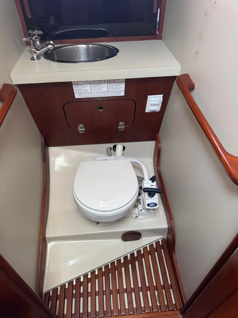 Slide: The Image of Compact marine bathroom in a 1985 Bayfield 32 sailboat with toilet and sink. - 24