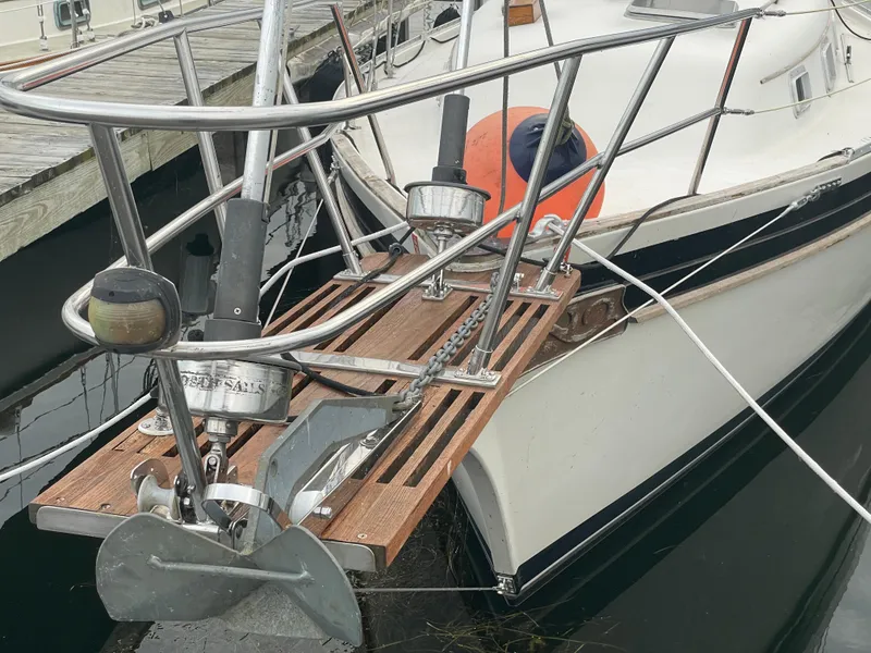 Slide: The Image of 1985 Bayfield 32 sailboat bow with anchor and wooden platform at dock. - 7