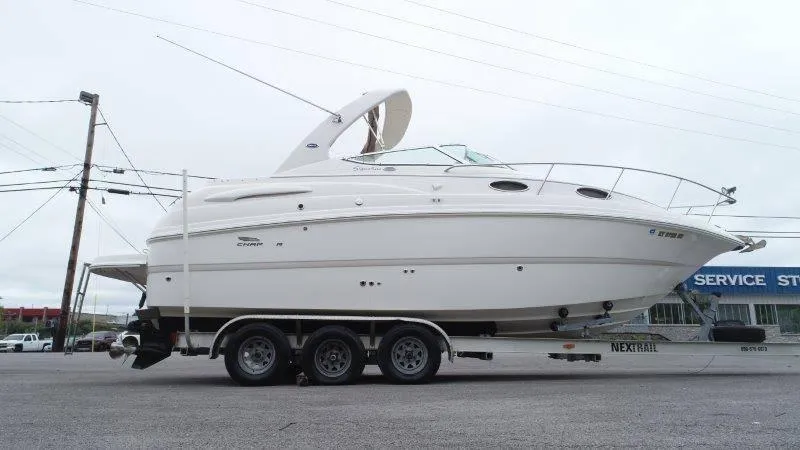 Slide: The Image of 2004 Chaparral 260 Signature boat on trailer in parking lot. - 11