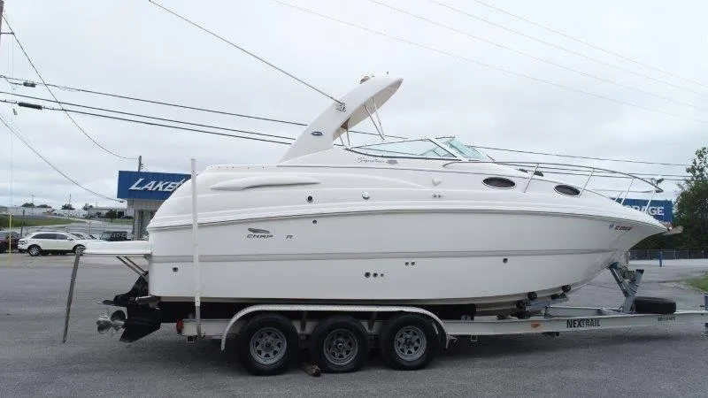 Slide: The Image of 2004 Chaparral 260 Signature boat on trailer in parking lot. - 14