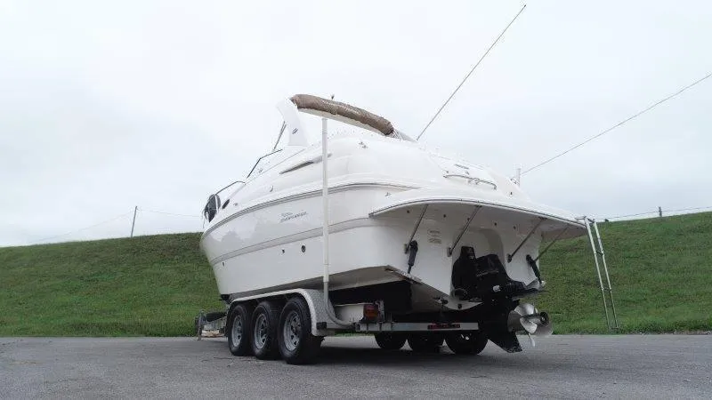 Slide: The Image of 2004 Chaparral 260 Signature boat on trailer, parked outdoors. - 17