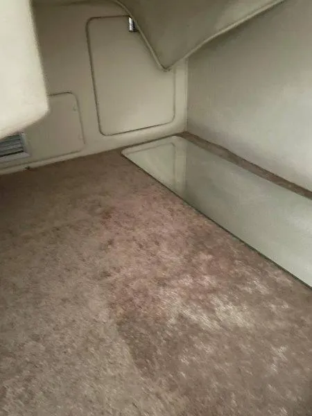 Slide: The Image of Interior cabin of 2004 Chaparral 260 Signature boat, featuring carpeted flooring. - 21