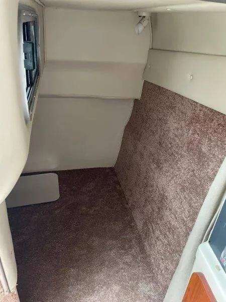 Slide: The Image of 2004 Chaparral 260 Signature cabin interior with beige and brown upholstery. - 22