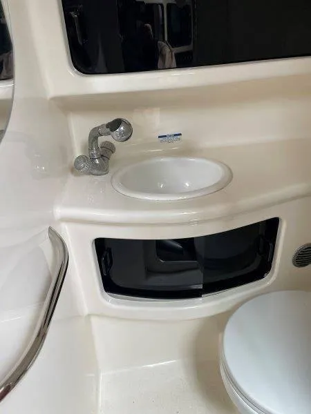 Slide: The Image of 2004 Chaparral 260 Signature boat bathroom with sink and storage. - 26