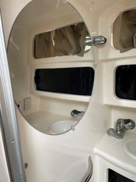 Slide: The Image of 2004 Chaparral 260 Signature boat bathroom with mirror and sink. - 28