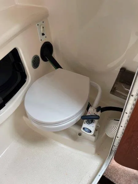 Slide: The Image of 2004 Chaparral 260 Signature boat bathroom with compact marine toilet. - 29