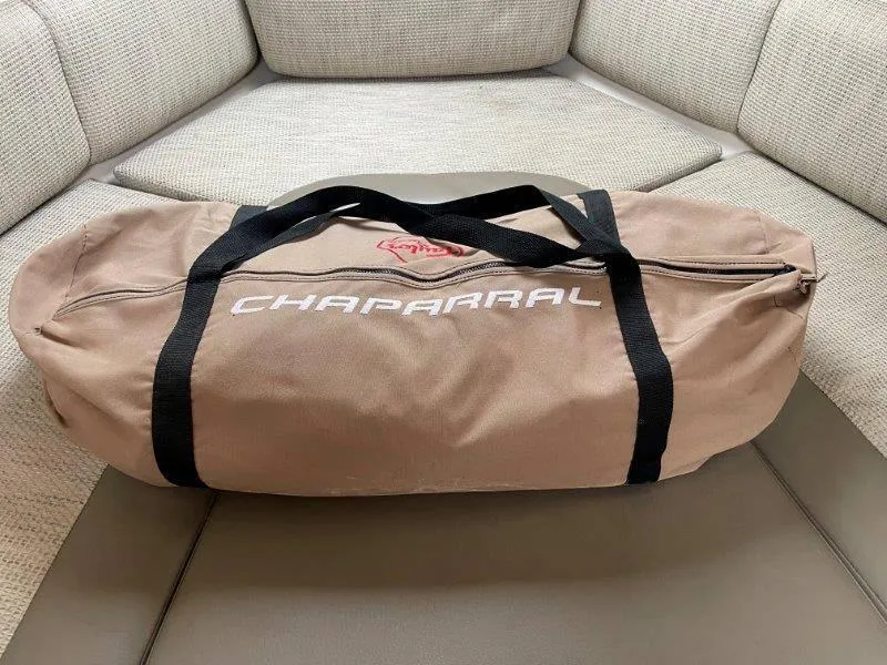 Slide: The Image of Brown Chaparral duffel bag on beige cushioned seating, 2004 Chaparral 260 Signature. - 30