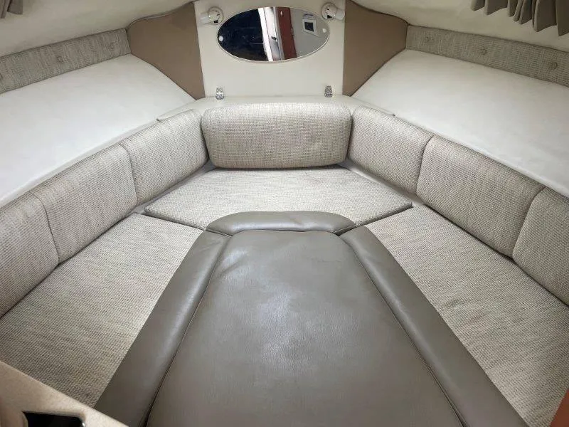 Slide: The Image of 2004 Chaparral 260 Signature boat interior with beige upholstery and compact seating area. - 33