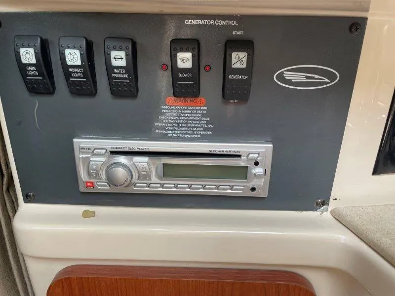 Slide: The Image of Control panel of 2004 Chaparral 260 Signature boat with CD player and generator controls. - 39