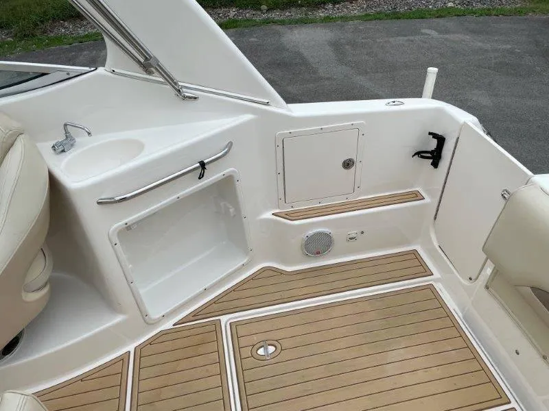 Slide: The Image of 2004 Chaparral 260 Signature boat interior with sink and wood flooring. - 42