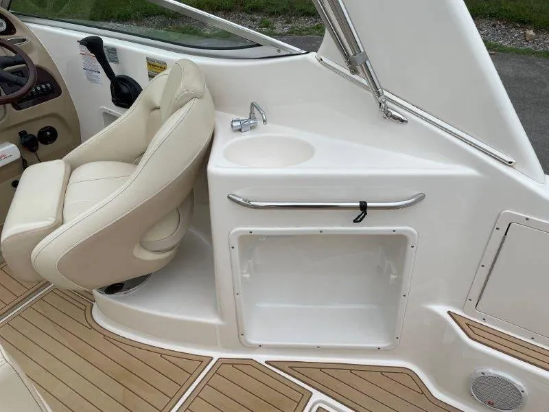 Slide: The Image of 2004 Chaparral 260 Signature boat interior with helm seat and sink. - 44