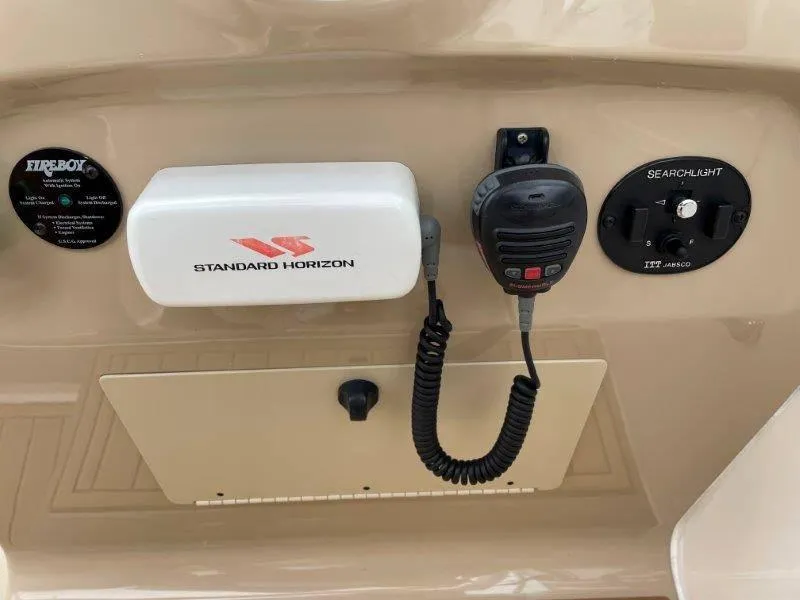 Slide: The Image of Control panel of 2004 Chaparral 260 Signature with Standard Horizon radio and searchlight controls. - 46