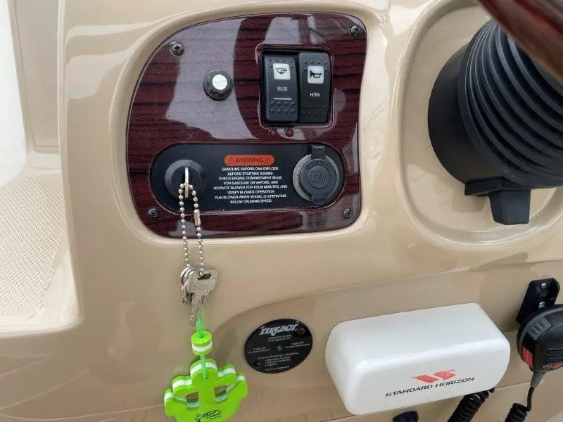 Slide: The Image of Control panel of a 2004 Chaparral 260 Signature boat with ignition and switches. - 47