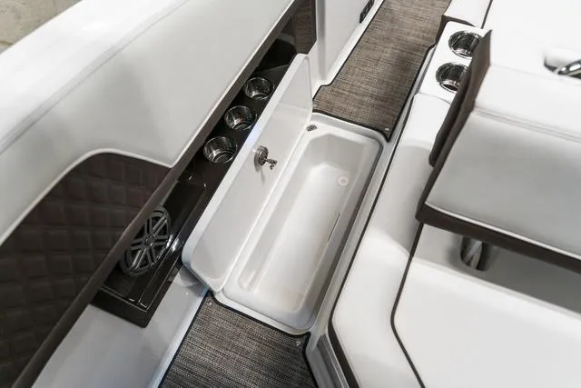 Slide: The Image of Interior of 2025 Cobalt R33 boat with storage compartment and cup holders. - 10